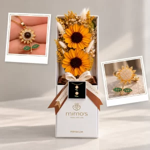 Box con dos girasoles eternos, follaje y cofre con collar y anillo antiestrés